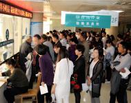 檢驗(yàn)科采血處排滿了前來檢查的患者，把過道堵得嚴(yán)嚴(yán)實(shí)實(shí)。