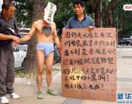 2011年11月22日，深圳福田區(qū)東園路上，河南籍農(nóng)民工韓文德雇人頭戴“黑心老板”面具，只穿一條內(nèi)褲走在街上，這么做是為了討要承包方欠下的21萬元工錢。他表示，自己和13名老鄉(xiāng)去年底參與深圳某大廈外墻翻新工程，今年8月完工后沒拿到應(yīng)得的工資，希望這樣的方式能引起有關(guān)方面的重視。經(jīng)記者調(diào)查發(fā)現(xiàn)，勞資雙方的合同沒有文字憑據(jù)，成了一筆死無對(duì)證的“糊涂賬”。新華社發(fā)